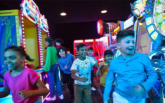 A group of kids having fun in arcade games area