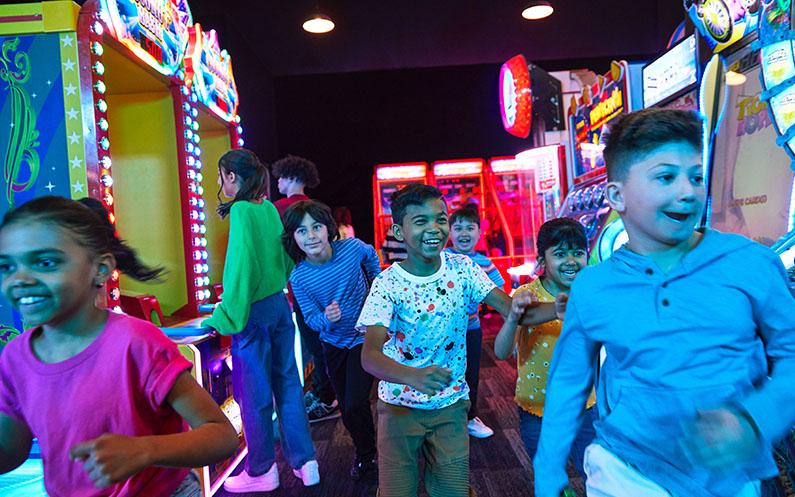 A group of kids having fun in arcade games area