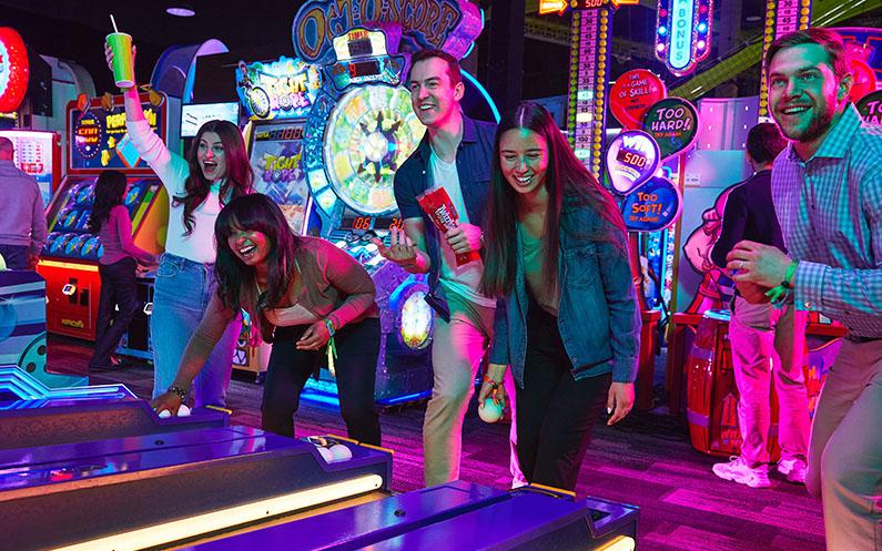 A group of friends playing games at Playdium