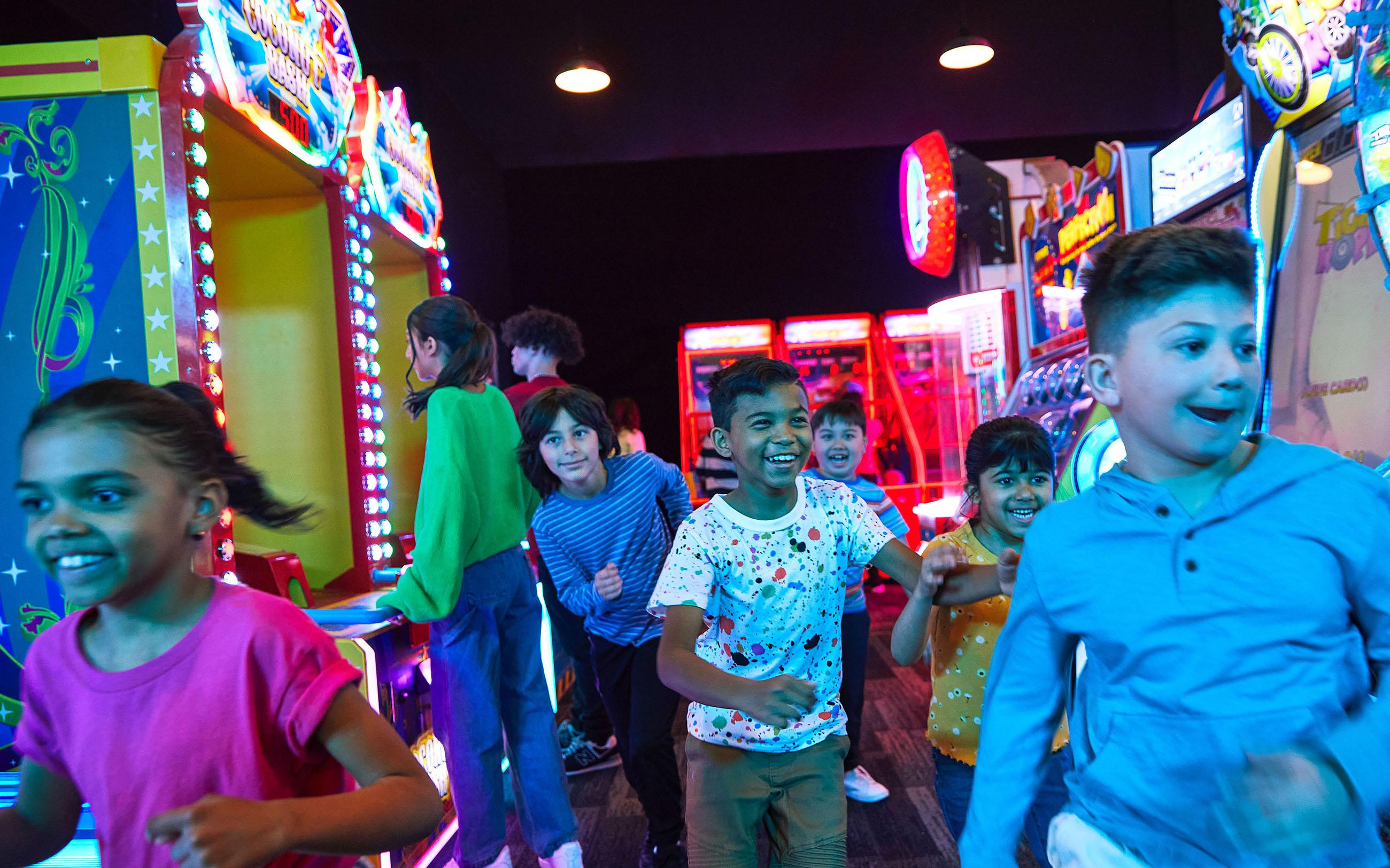 A group of kids having fun in arcade games area